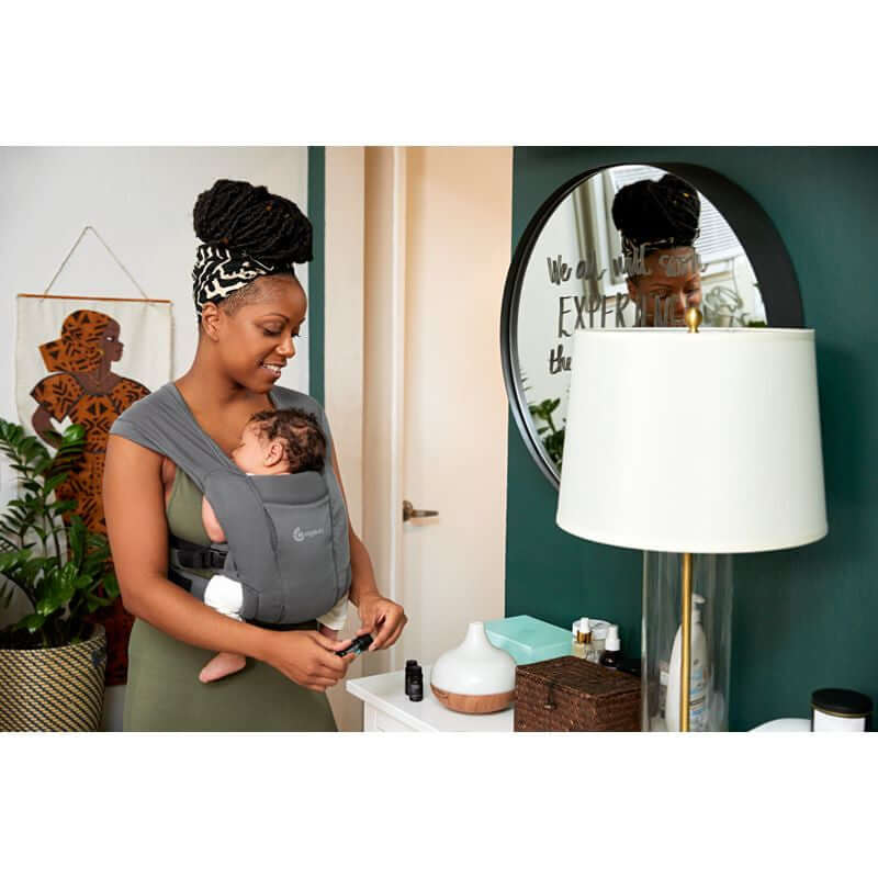 Mom using Ergobaby Embrace Soft Air Mesh - Washed Black baby carrier with newborn at home | Babymaxi