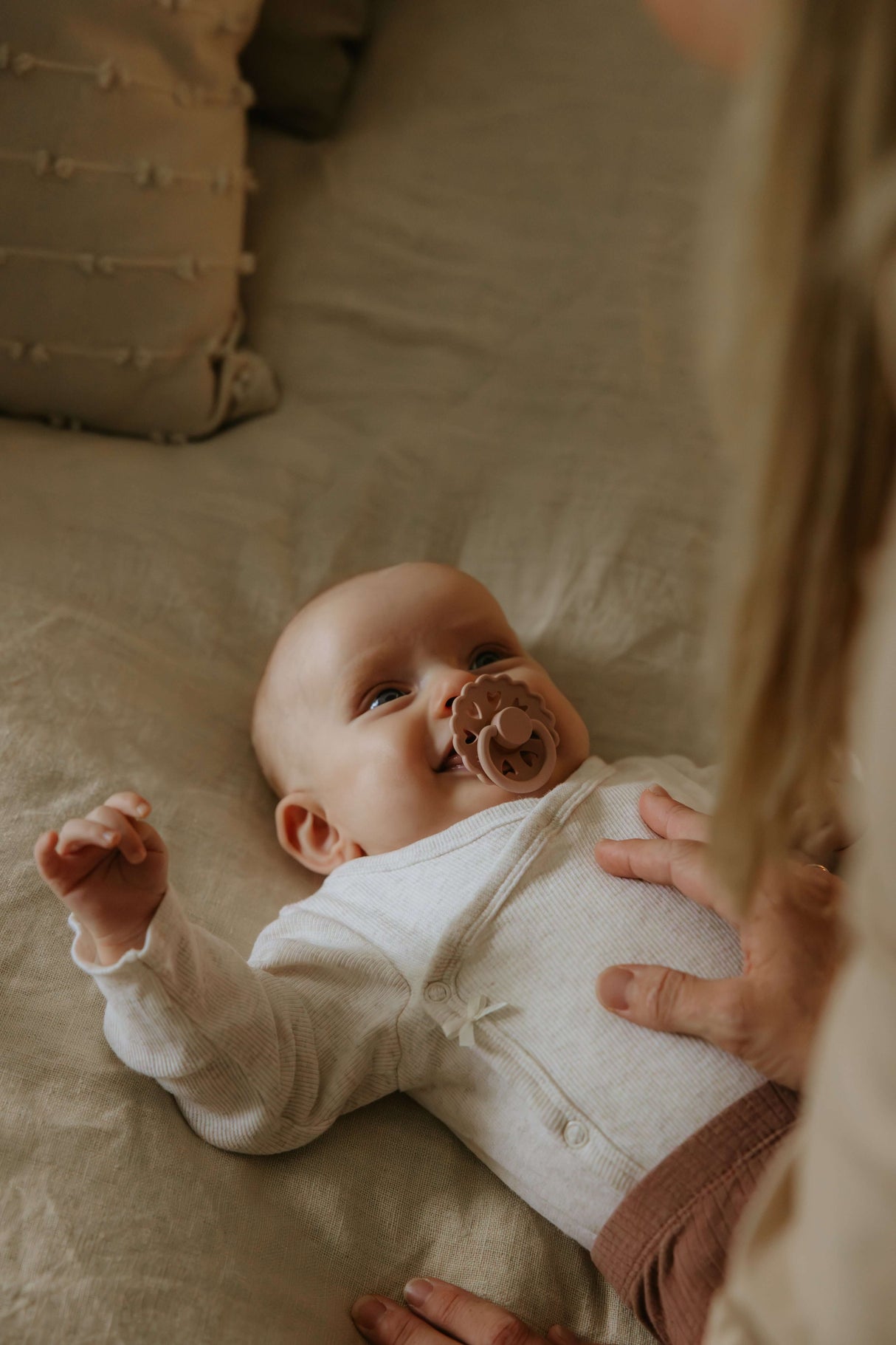 Baby smiling with a 6-Pack Silicone Pacifier Box – Safe, Non-Toxic & Sustainable in mouth, enjoying comfort and safety | Babymaxi