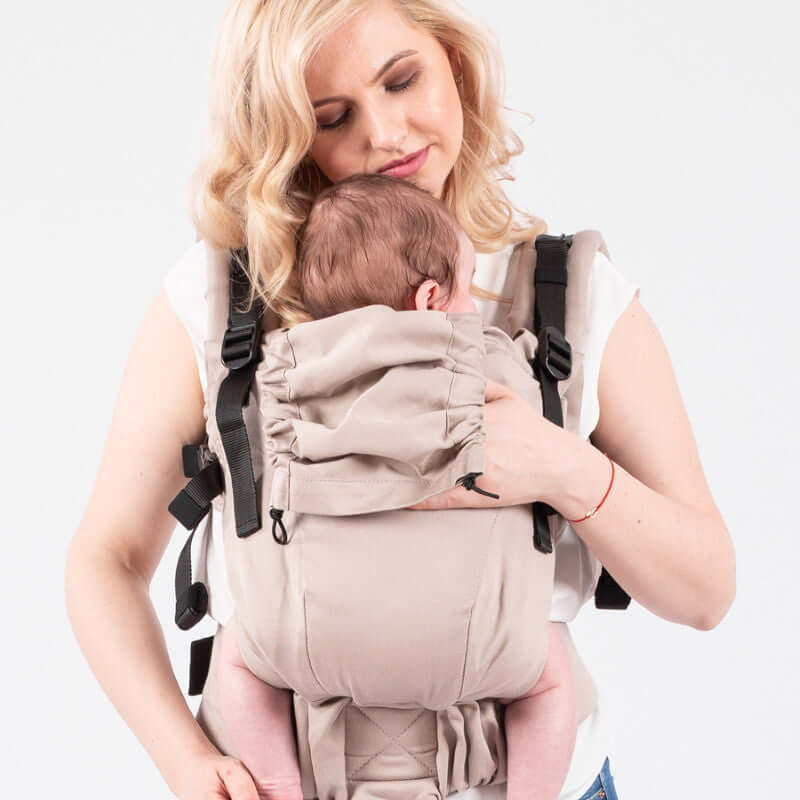 Isara The One - Caffe Latte baby carrier being used by a parent, showcasing ergonomic comfort for all ages | Babymaxi