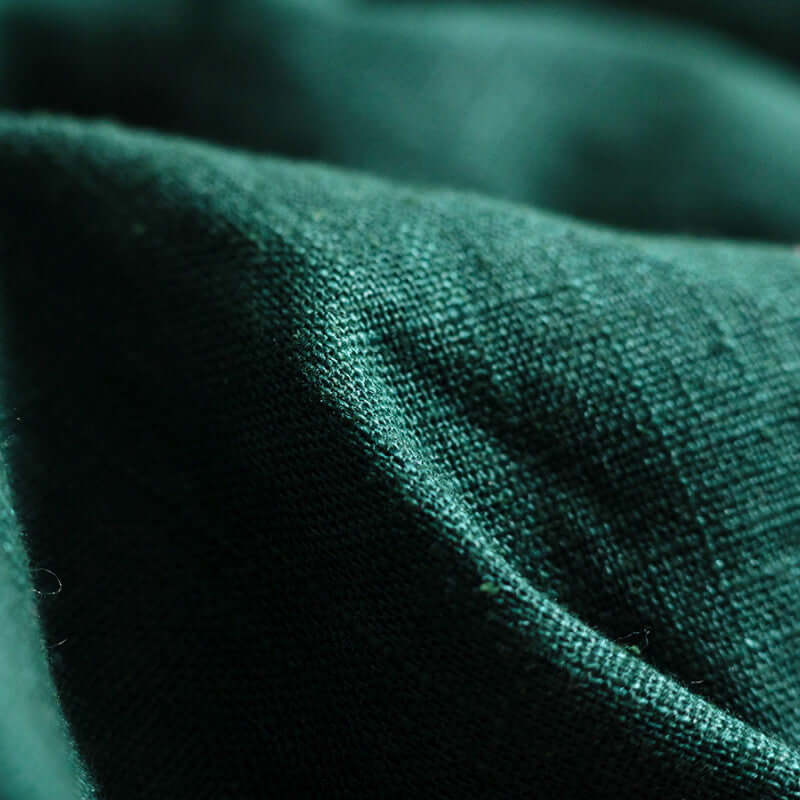 Close-up of ISARA The One - Evergreen Linen fabric, showcasing its soft texture and rich green color | Babymaxi