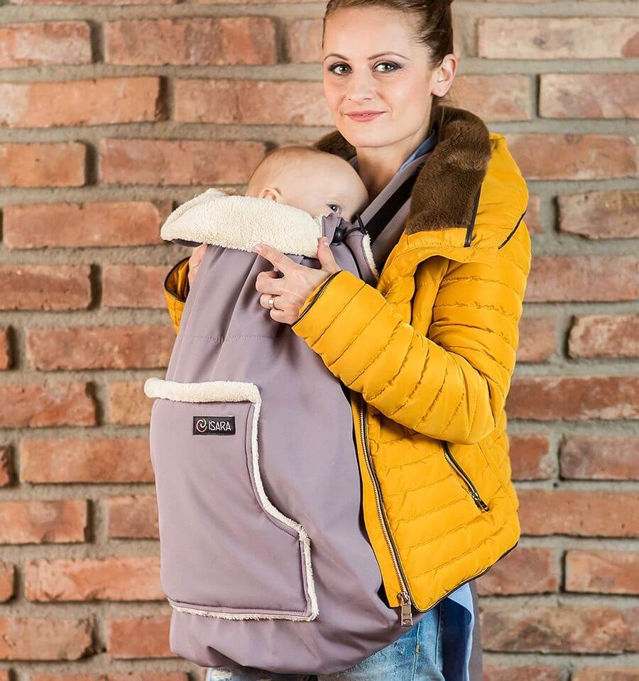 Woman wearing the Isara Winter Baby Carrier Cover - Frosted Almond Taupe with baby, cozy style for cold weather | Babymaxi