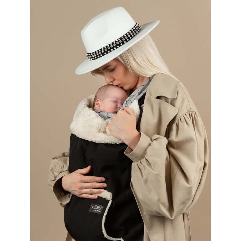 Isara Winter Baby Carrier Cover - Ultra Black in use with a cozy baby, perfect for winter babywearing | Babymaxi