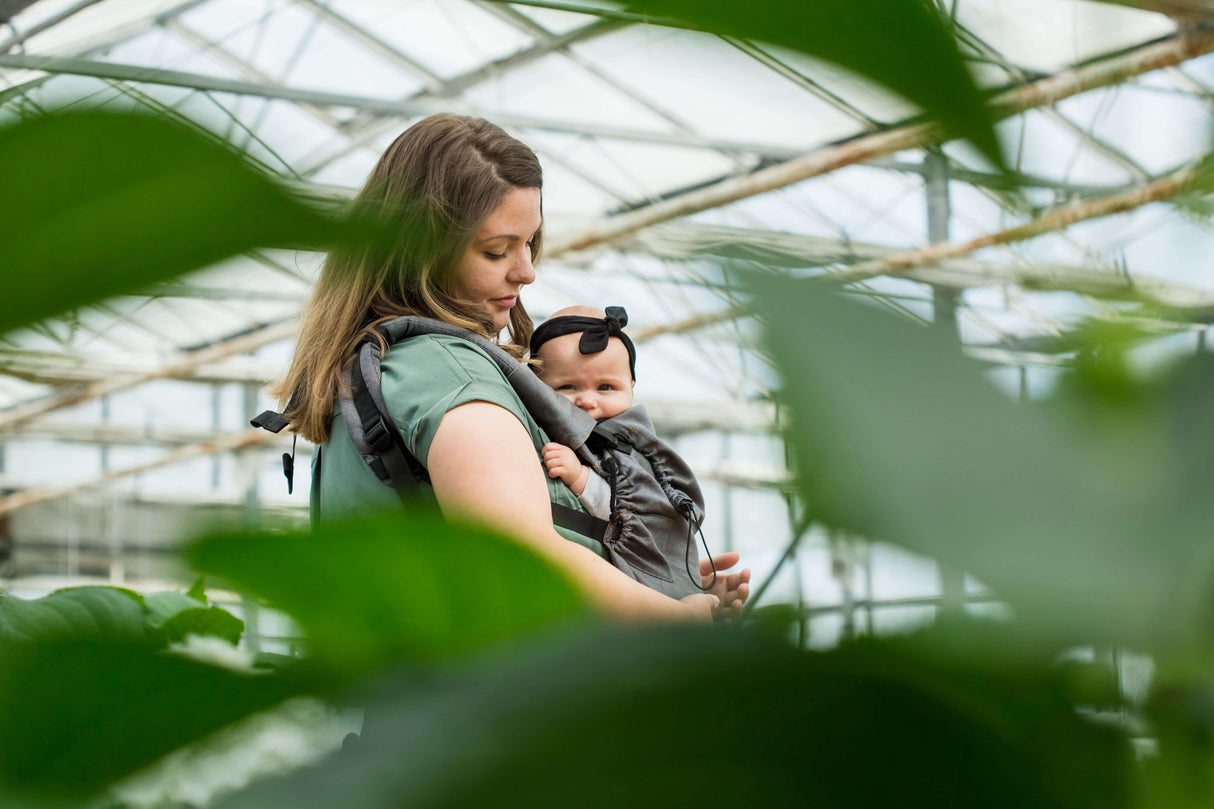 Neko Switch Baby Carrier - Bold, 2 extra hoods being used in a greenhouse with a parent and baby | Babymaxi