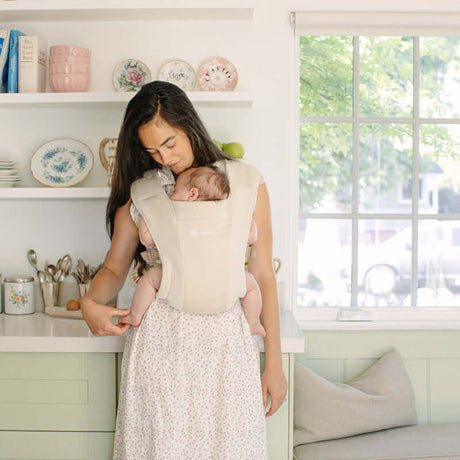 Ergobaby Embrace, Cosy Carrier - Cream in use, mother holding baby, soft and comfortable babywearing | Babymaxi