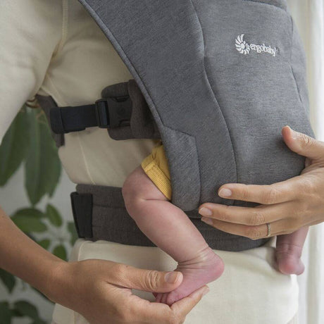 Ergobaby Embrace - Heather Grey baby carrier showing soft fabric and newborn in belly carry | Babymaxi
