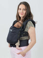 Isara The One - Noire ergonomic baby carrier with a parent carrying an infant comfortably | Babymaxi