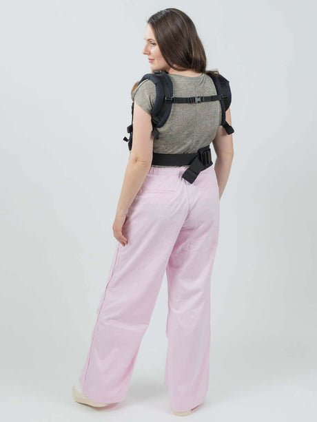 Isara The One - Noire ergonomic baby carrier worn by user, showcasing adjustable design for all body types | Babymaxi