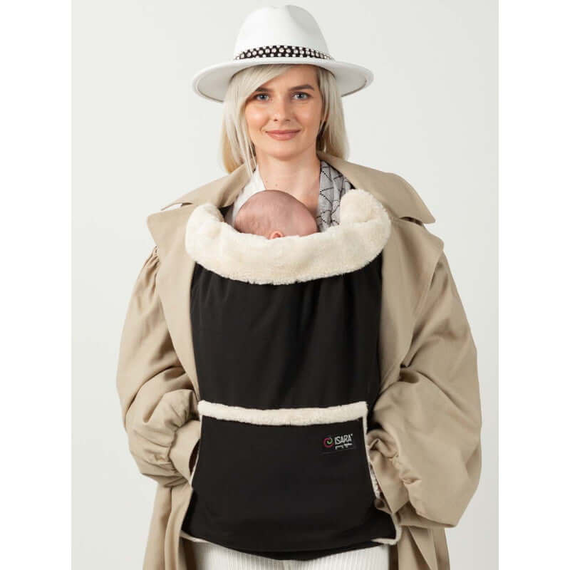 Woman wearing Isara Winter Baby Carrier Cover - Ultra Black, keeping baby warm in cozy fleece during winter.| Babymaxi