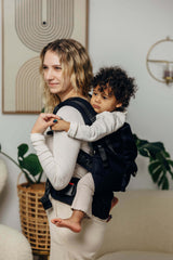 LennyLamb LennyPreschool (up to 30kg) - Little Herringbone Ebony Black toddler carrier in use, supporting a child comfortably | Babymaxi
