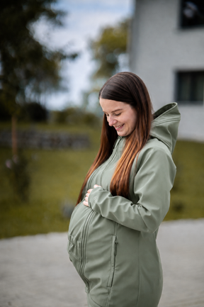 Mamalila Softshell Babywearing Jacket Allrounder Fit Agave, smiling pregnant woman wearing maternity jacket outdoors