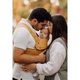 Marsupi Classic - Butterscotch baby carrier in use by parents with infant, ensuring ergonomic support | Babymaxi
