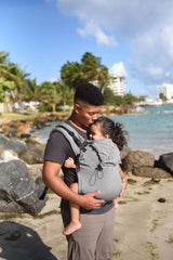 Neko Switch Toddler Carrier - Bold being used on a beach with a child, showcasing ergonomic comfort and adjustability | Babymaxi