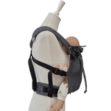Stochenwiege Valeno Baby Carrier - Graphite on mannequin holding a baby doll, showcasing ergonomic design | Babymaxi