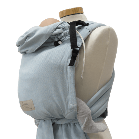 Storchenwiege Talemo BabyCarrier - Aqua displayed on mannequin, featuring adjustable buckle waist and wrap-style shoulder straps | Babymaxi