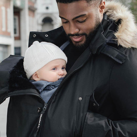 Wombat & Co. London - Bandicoot Baby Carrier Coat for Men - Black with a dad and his baby in a cozy winter setting | Babymaxi