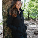 Wombat & Co. London - Shell Baby Carrier Coat - Black worn by a woman outdoors, showcasing versatile maternity and babywearing style | Babymaxi