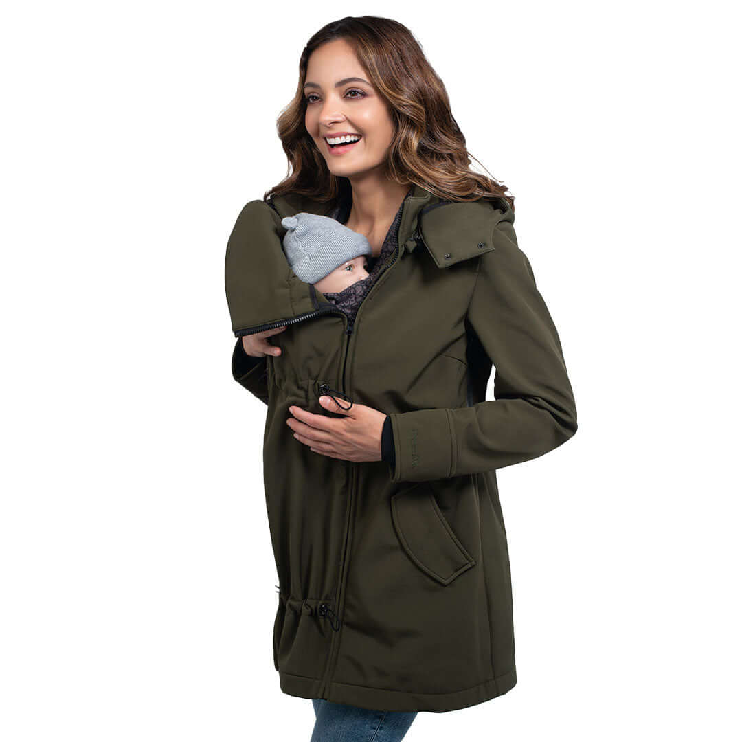 Wombat & Co. London - Shell Babywearing Coat - Camo Green featuring a mother holding her baby, stylish and versatile winter jacket | Babymaxi