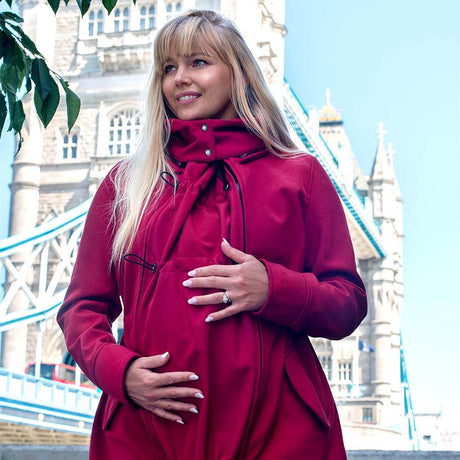 Wombat & Co. London - Shell Babywearing Coat - Cherry Red worn by pregnant woman outdoors | Babymaxi