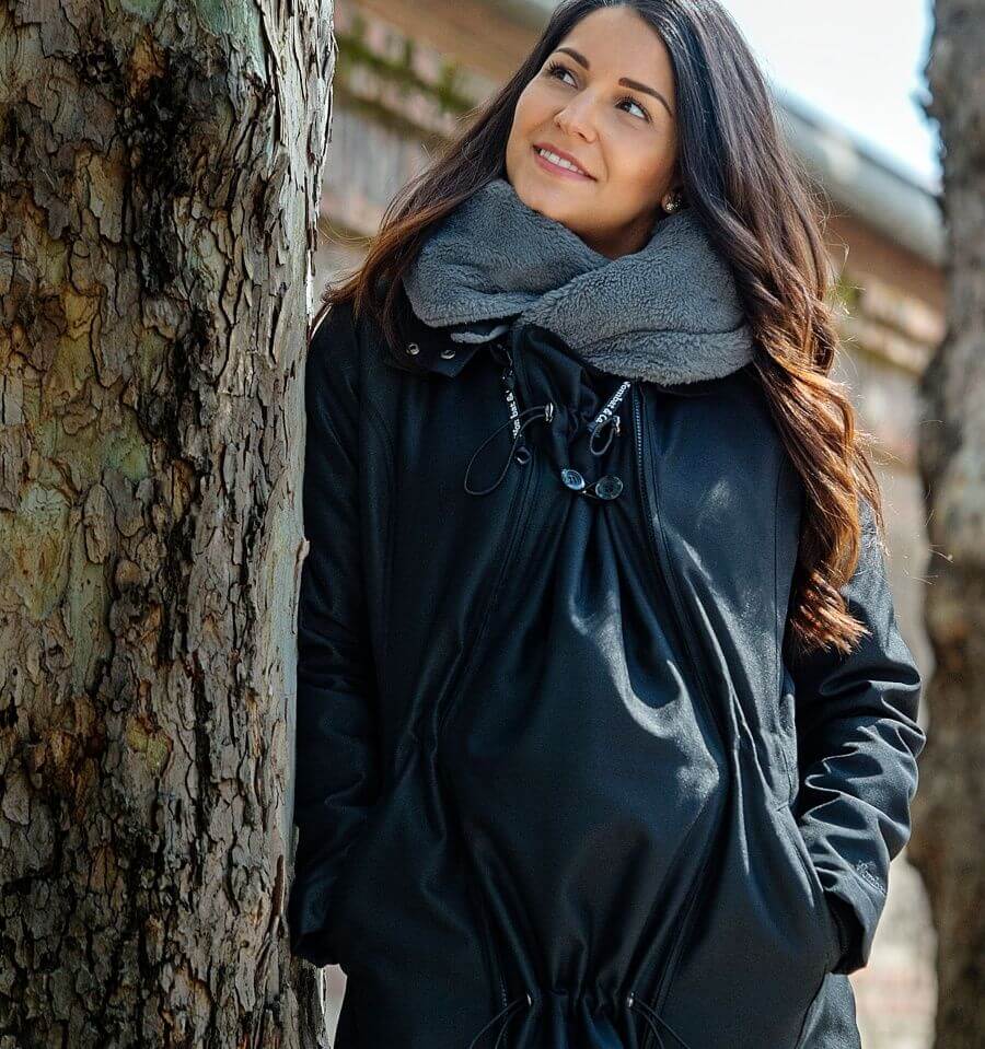 Wombat & Co. London - Wallaby Babywearing Jacket – Black & Charcoal worn by a woman outdoors | Babymaxi