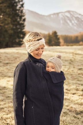 Mamalila Eco Wool Babywearing Coat Oslo - Navy on mother with baby in carrier, showcasing warmth and style | Babymaxi